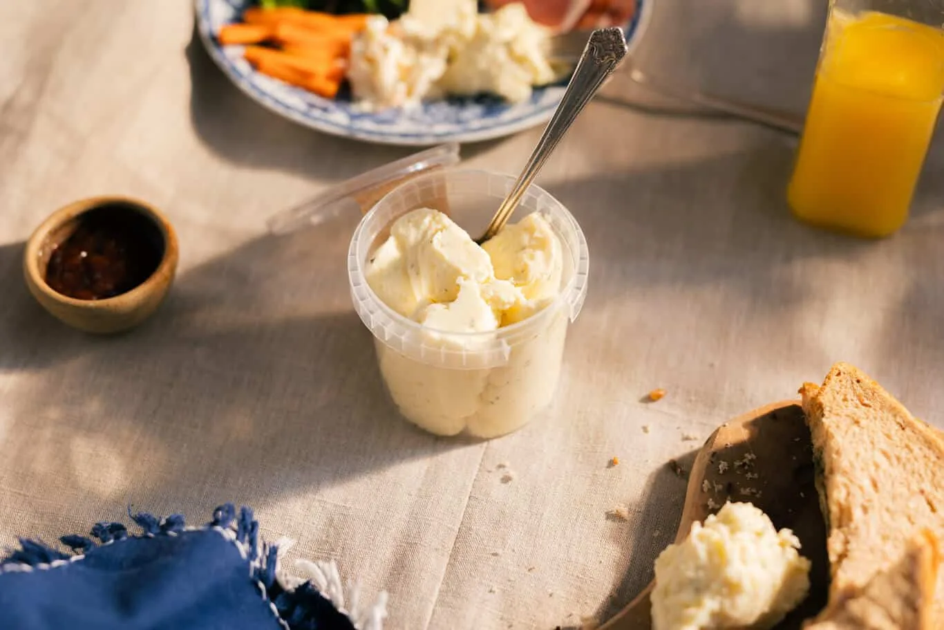 Table with Baile an Ard potato salad, bread, and orange juice.